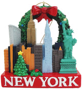 A Christmas Ornament showcasing famous landmarks from New York City, like the statue of liberty, the Empire State Building, and the famous New York skyline. On the bottom is written New York.