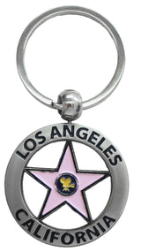 Keychain with Los Angeles written on a circle, and a Hollywood pink star in the middle